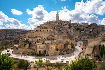 Nestled in the hills, Matera reveals its stunning stone buildings and winding streets under a...