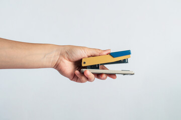 Stapler in hand isolated on white background
