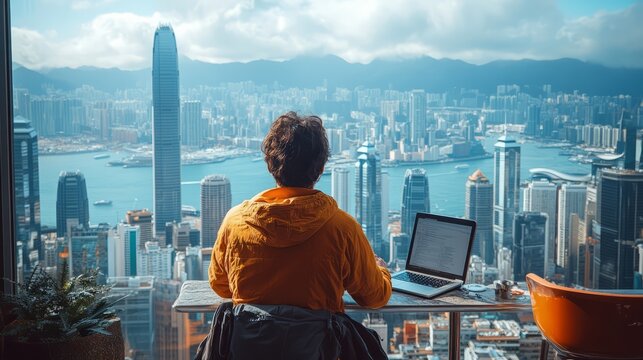 A digital nomad working on a laptop at a rooftop cafe in a bustling city