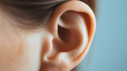 Fototapeta premium Close-up of a human ear revealing intricate details and textures, perfect for concepts related to hearing, anatomy, or personal care. Isolated on a soft focus background.