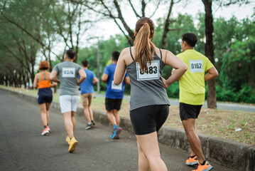 back view of female athlete participating at marathon competition