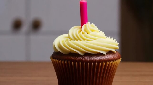 Birthday Cupcake Delight - A festive cupcake topped with a single candle awaits celebration.