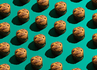 Pattern of freshly baked panettone on green background