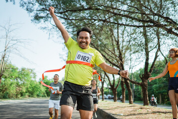 happy marathon winner with hands up gesture to celebrate victory