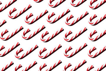 Top view of assorted red and white candy canes on white background making a pattern