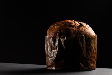 Christmas panettone on a dark background with dramatic lighting copy space