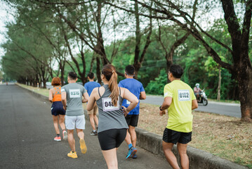 back view of sporty people participating on marathon competition