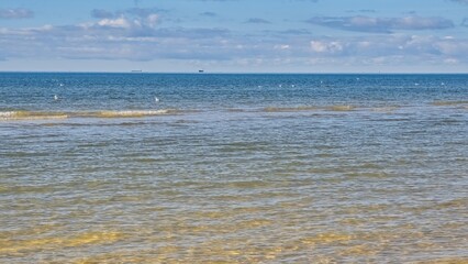 Obraz premium Baltic Sea. Shallow water. Calm. Vessels in the roadstead.