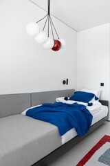 A Beautiful Modern Bedroom Featuring Stylish Lighting and Cozy Decor for Relaxation