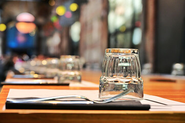 perspective view of deserted long bistro table arranged for lunch