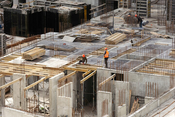 Concrete pump on top floor of building under construction. huge concrete pump with tall arm over...