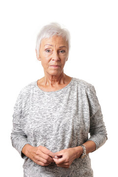 senior woman with short gray hair and a serious expression isolated on white background