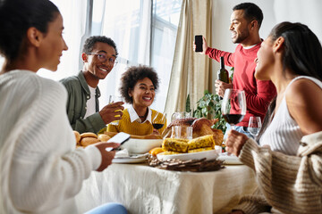 A group of friends shares a festive Thanksgiving feast filled with joy and camaraderie at home.