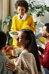 A group of friends enjoying a hearty Thanksgiving meal, filled with laughter and warmth.