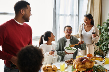 A group of friends shares a warm Thanksgiving meal together, enjoying food and laughter.