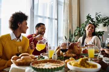 A group of friends shares a warm Thanksgiving dinner, enjoying good food and each other’s company.