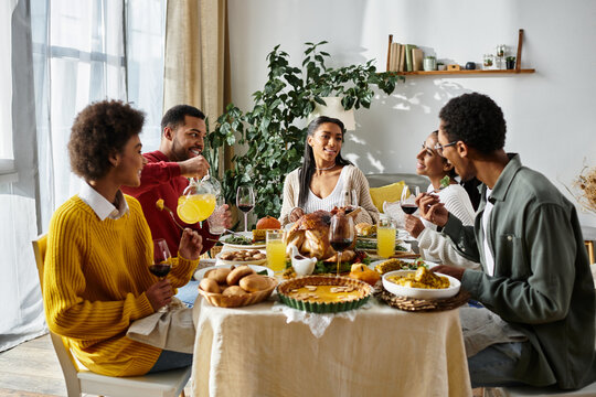 Friends enjoy a warm Thanksgiving gathering at home, sharing laughter and delightful dishes.