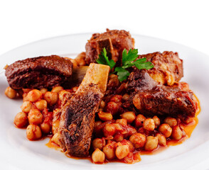 Delicious braised lamb shanks with chickpeas served on white plate