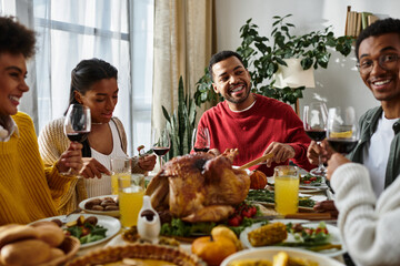 Friends savor a Thanksgiving meal together, enjoying good food and each others company.