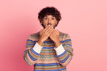 Portrait of nice young man arms cover mouth wear pullover isolated on pink color background