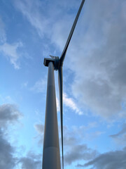 Close-up of wind turbine against blue sky. Concept of green, clean, renewable energy.