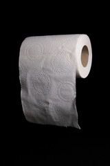 White Toilet Paper Roll With Circle Embossed Design on Black Background