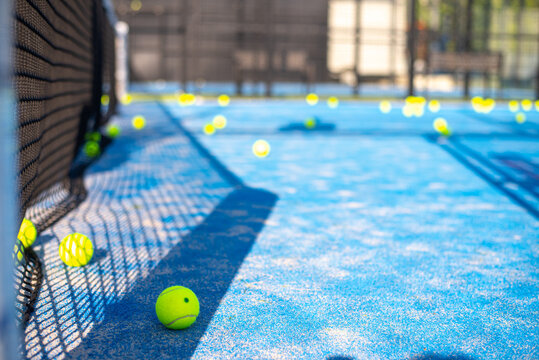 tennis ball on blue court lie near net. space for text. sport tennis or padel.  activity interesting game. trading.