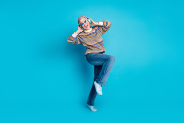 Full length photo of overjoyed person wear ornament pullover in sunglass touch headphones dancing...