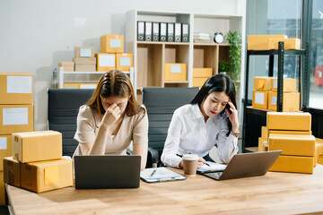 Asian team owner woman prepare parcel box  woman is stressed, bored, and overthinking from working
