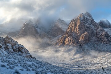 The mountain in Nevada is after a snow storm. Clouds are low and touch the mountain.