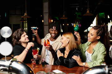 A lively gathering of young professionals celebrating with colorful drinks and laughter.