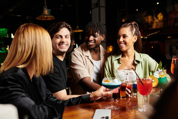 A lively gathering of young professionals celebrating collaboration and success.