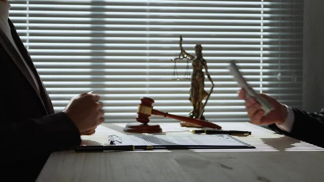 Two businessmen are shaking hands after one of them giving money under the table to his accomplice