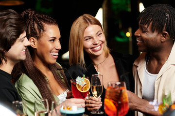 A group of joyful colleagues share drinks and laughter during a corporate party gathering.