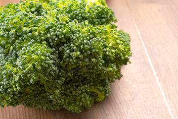 Raw fresh broccoli on old wooden table.