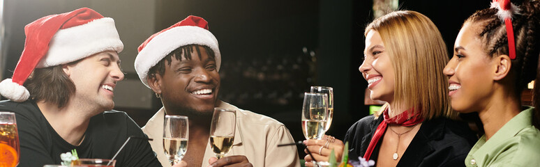 Young professionals enjoy a festive celebration, sharing laughter and drinks at a corporate event.