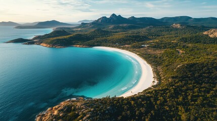 Fototapeta premium Aerial View of Pristine Beach with Turquoise Waters and Mountain Range