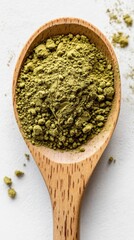 wooden spoon with green powder of matcha on white background, closeup macro shot, top view. health, wellness, natural ingredients poster, traditional Japanese tea culture