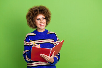 Photo of lovely cute woman wear blue striped stylish clothes hold planner look empty space isolated on green color background