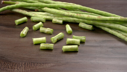 French beans with stewed green peas on wooden background. Healthy food concept.