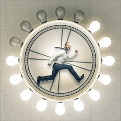 Businessman running inside lightbulb clock pursuing success
