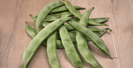 Pile of green beans over wooden background, Healthy food concept