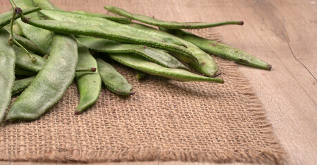 Pile of green beans over wooden background, Healthy food concept