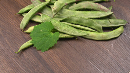 Pile of green beans over wooden background, Healthy food concept