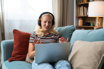 Young woman talking on video call with her psychotherapist doctor after online therapy sessions,...