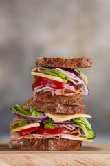 Big healthy sandwich for breakfast, with ham, cheese, homemade curry sauce, tomato, cucumber,...