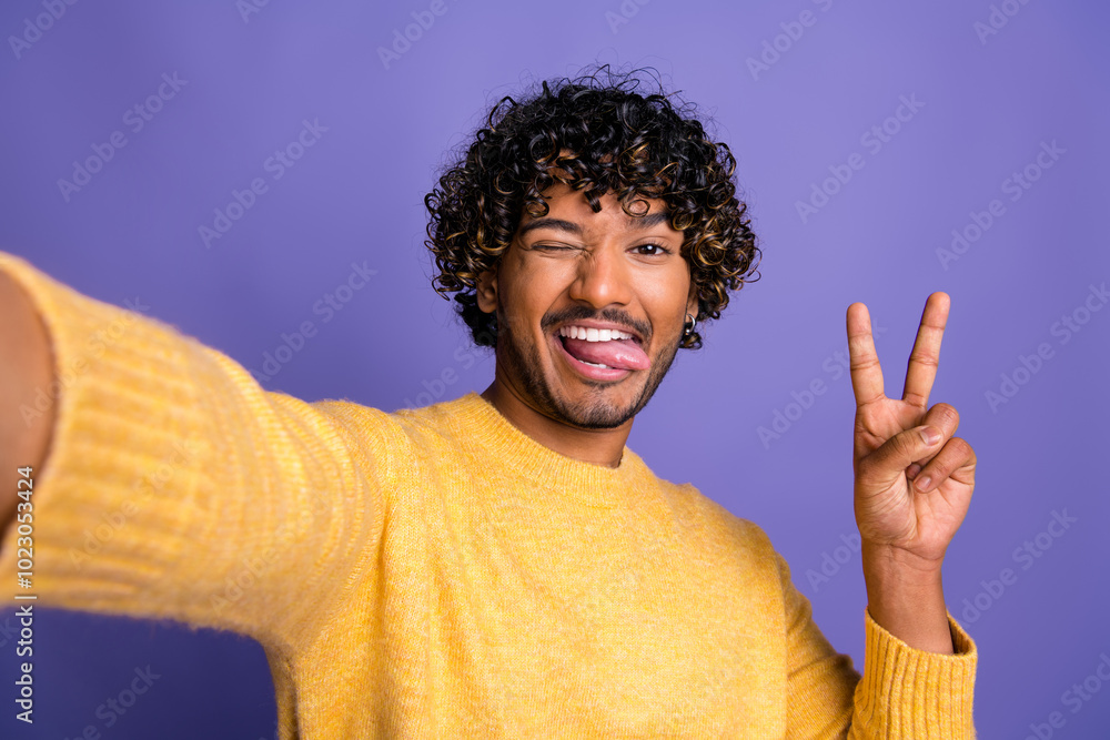 Poster Photo of positive cheerful blogger man wear stylish clothes make video v-sign isolated on violet color background