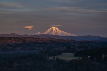 Beautiful sunset at Oregon's icon Mount Hood. Golden hour sunlight showing off the snow peak. High quality picture for download.