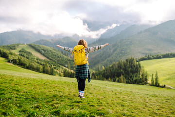 Happy Woman tourist admiring the landscape mountains nature. Exploring wilderness in National Park. Travel, hiking concept.