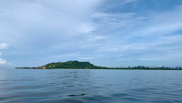 view from a distance of an island with the shape of a tablespoon